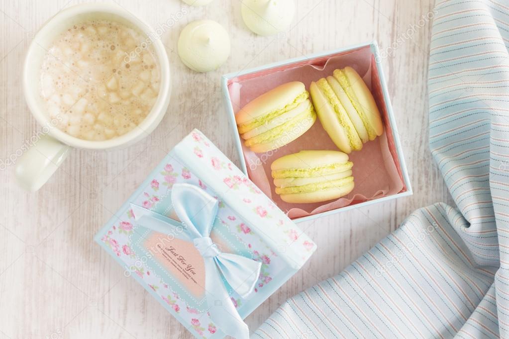 Yellow macaroons in gift box. Pastel colored