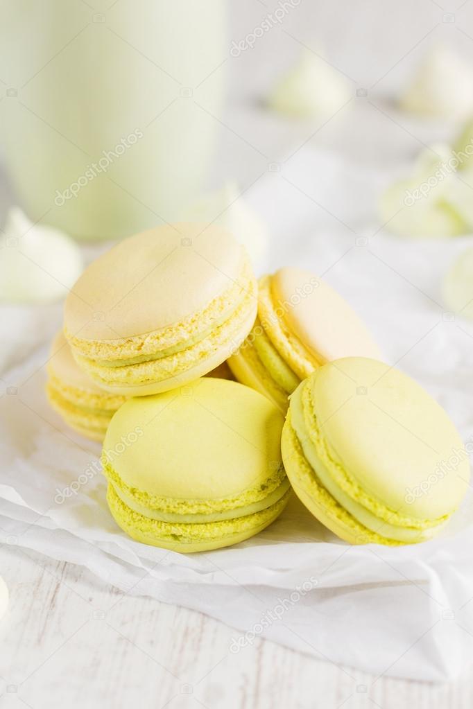 Green and yellow  macaroons with cup of coffee