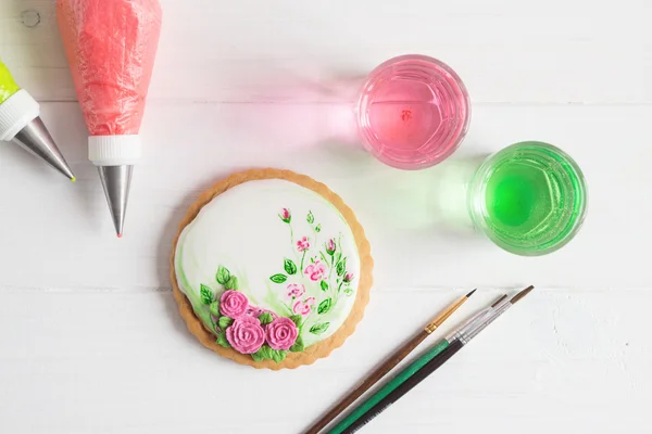 Painted gingerbread cookie with roses. Top view