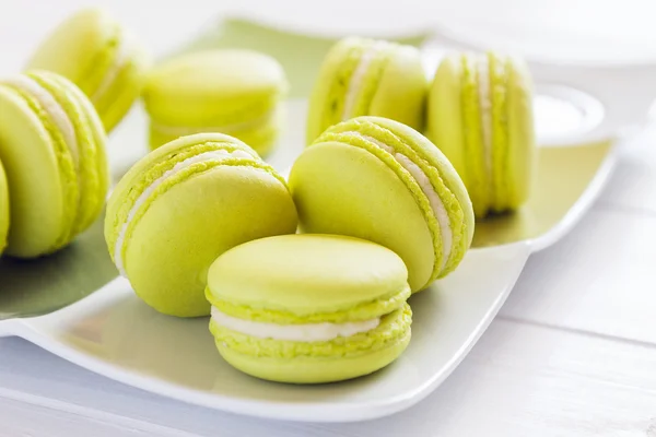 Close up green macaroons on white plate — Stock Photo, Image