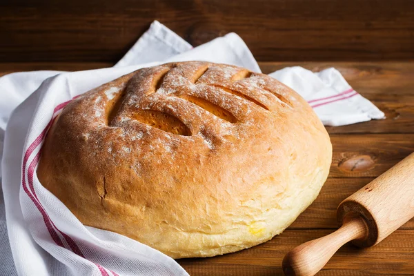 Freshly baked homemade bread on wooden background — Stock Photo, Image