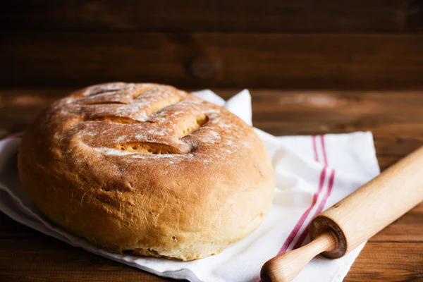 Freshly baked homemade bread on wooden background — Stock Photo, Image