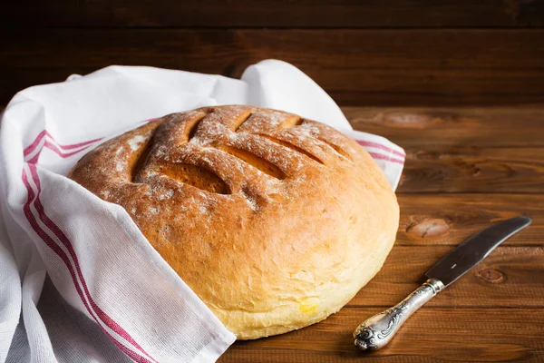 Freshly baked homemade bread on wooden background — Stock Photo, Image