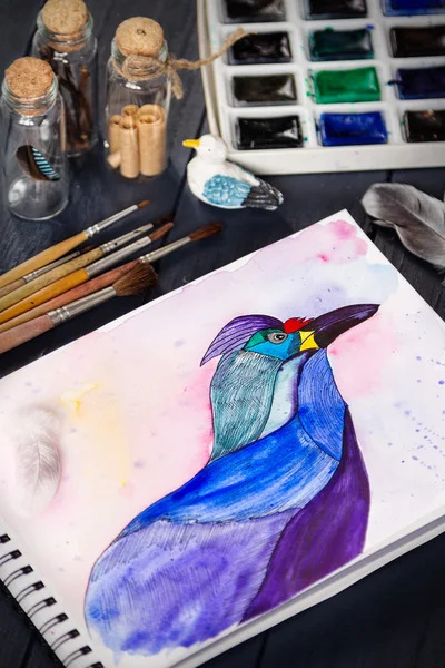 水彩绘画的蓝鸟和桌上的艺术工具 — 图库照片