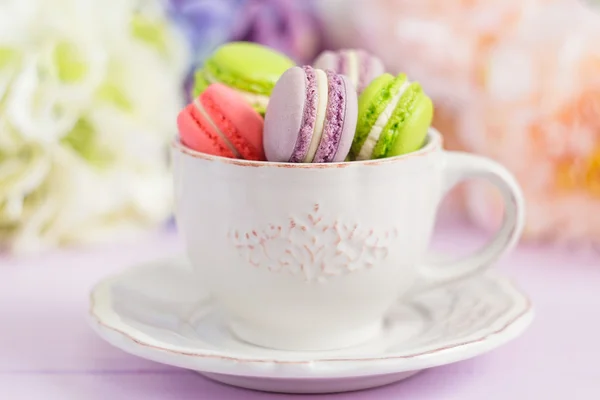Colorful tiny macaroons in the cup — Stock Photo, Image