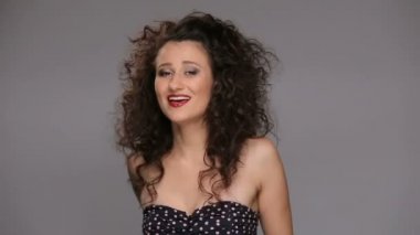 Genç esmer, uzun kahverengi kıvırcık saçlı dans eden