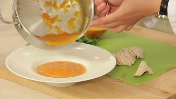 Шеф-повар готовит суп из морковного крема с тушеной индейкой Филе и свежей петрушкой — стоковое видео