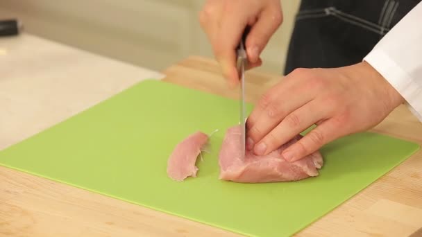 Chef coupe des filets de dinde sur une planche à découper — Video