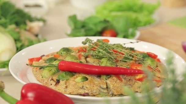 Présentation de l'omelette au paprika rouge, choux de Bruxelles et oignons aux herbes sur une assiette — Video