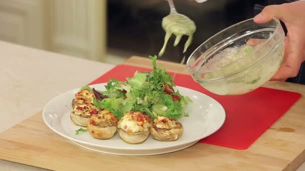 Stuffed champignon on white plate with salad — Stock Video