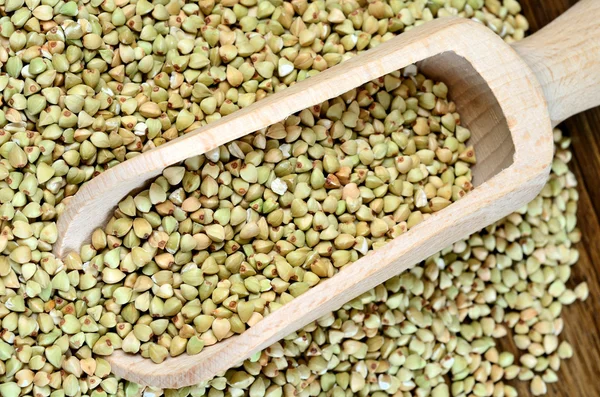 Green buckwheat in a wooden scoop — Stock Photo, Image