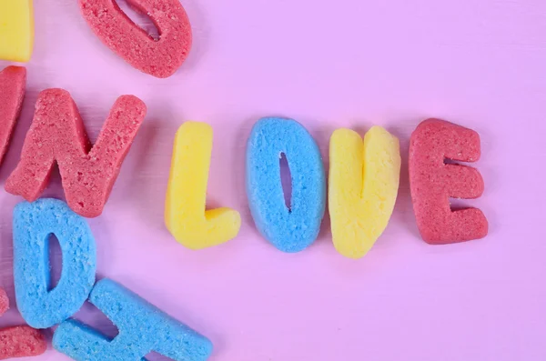 Word Love on pink table — Stock Photo, Image