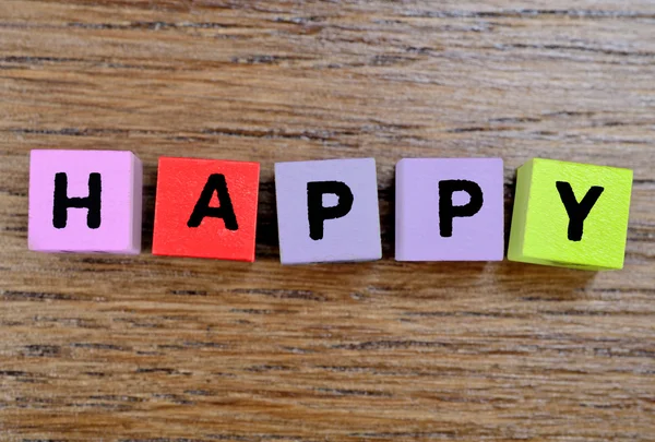 Palavra feliz na mesa — Fotografia de Stock