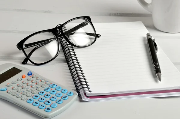 Notebook with eyeglasses and calculator — Stock Photo, Image