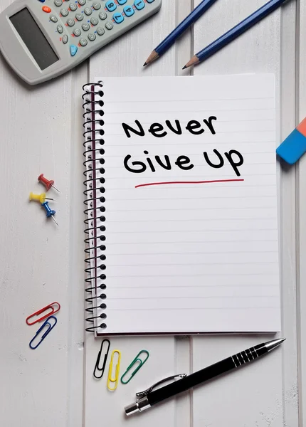 Never give up word on notebook — Stock Photo, Image
