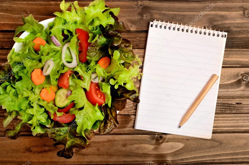 Notepad and vegetable salad