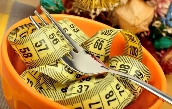 Bowl with centimeter and fork — Stock Photo, Image