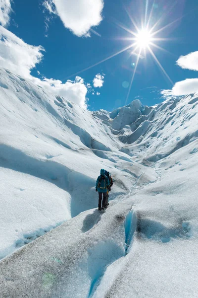 Két túrázó sétál a Perito Moreno gleccser jégtúrán. — Stock Fotó