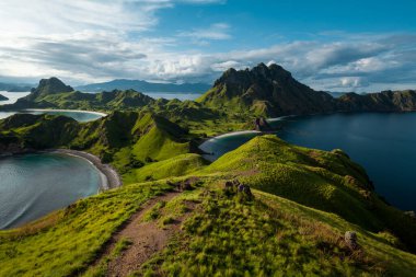 Padar adasının tepesinde yürüyen bir adam 