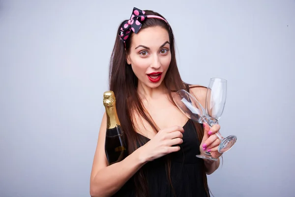 Beautiful girl with bottle of champagne — Stock Photo, Image