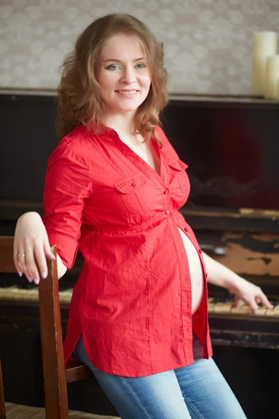 Zwangere vrouw in een rood shirt — Stockfoto