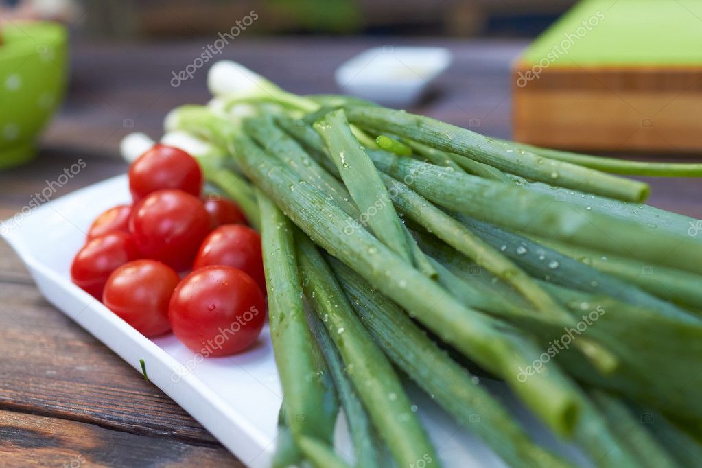 Cherry tomatoes and green onions — Stock Photo © nikolodion 112439214
