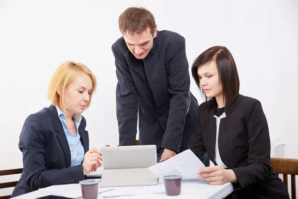 Three businesspeople working with tablet pc Royalty Free Stock Images