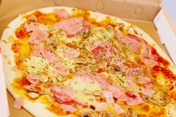 Pizza with ham and mushrooms