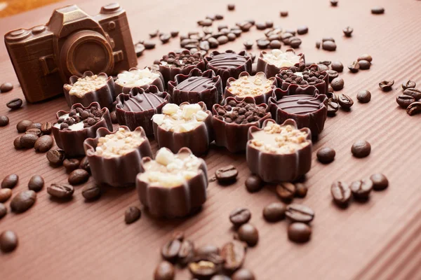 Chocolate candies and coffee beans — Stock Photo, Image