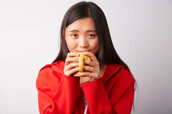 Chinesin trinkt aus einem Becher — Stockfoto