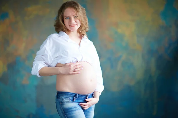 Zwangere vrouw in spijkerbroek — Stockfoto