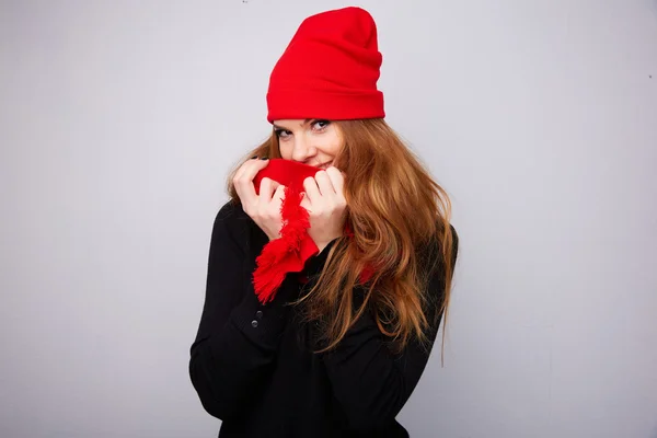 Red-haired girl in a red hat and scarf — Stock Photo, Image