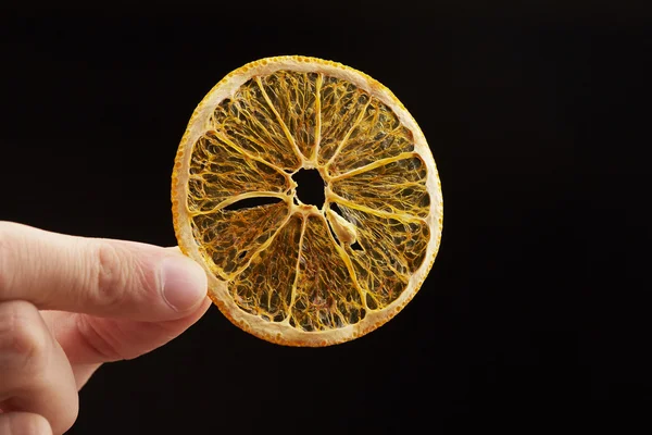 Dried orange slice in hand — Stock Photo, Image