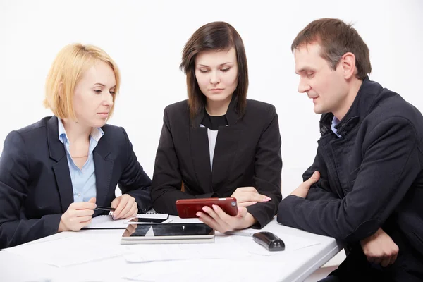 Three businesspeople working with tablet pc Royalty Free Stock Photos