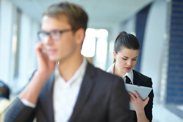 Empresária com tablet e empresário com telefone — Fotografia de Stock