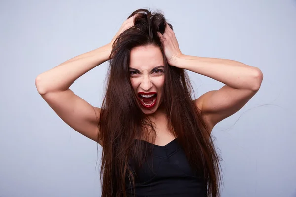 Woman screaming and holding head