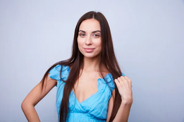 Girl with long dark hair smiling