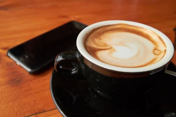 Cup of coffee and phone — Stock Photo, Image