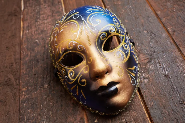 Venetian mask on wooden table — Stock Photo, Image