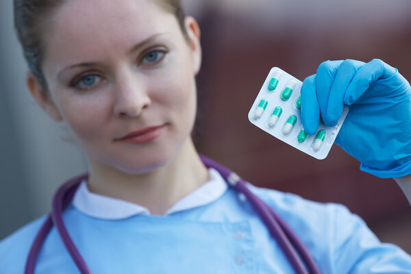 doctor with medicine capsules