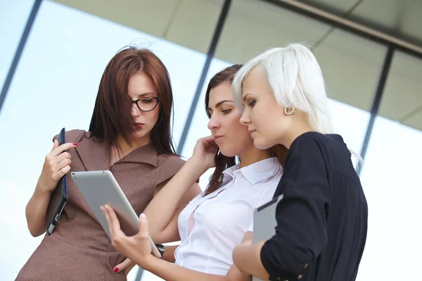 Group of businesswomen with digital gadgets Stock Image