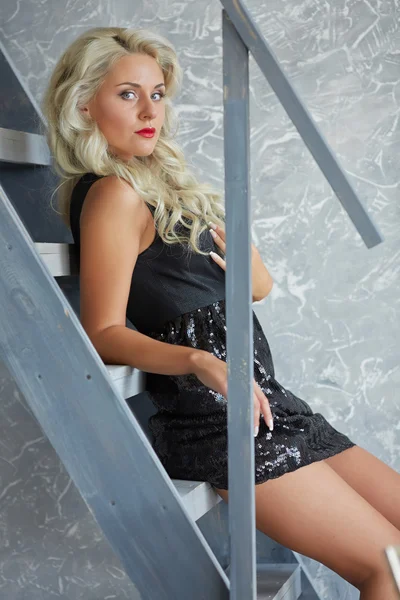 Mujer rubia posando cerca de escaleras —  Fotos de Stock