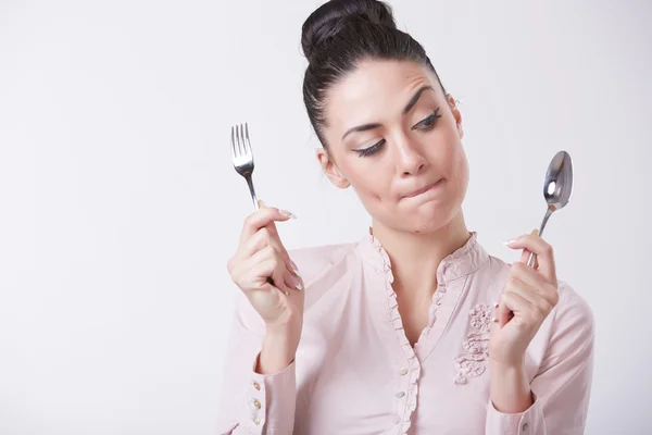 Woman with metal utensils Royalty Free Stock Photos