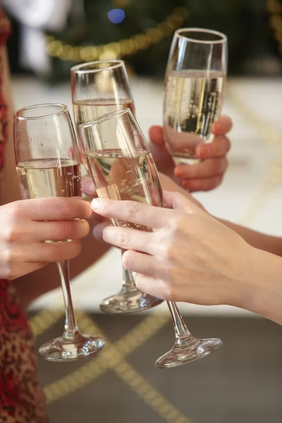 Glasses of champagne in female hands — Stock Photo, Image