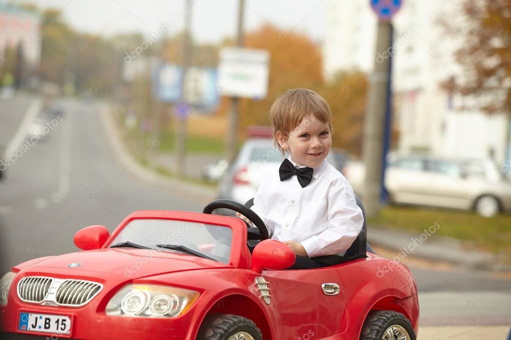 little boy driving car