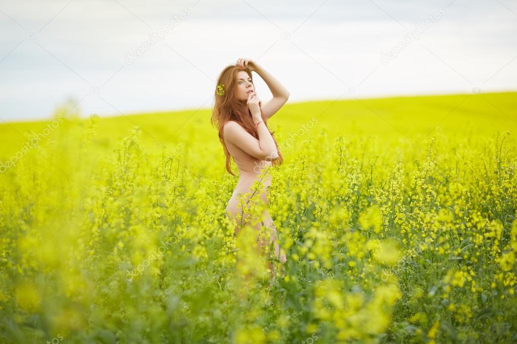nude woman in blooming field