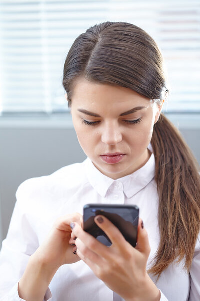 business woman with mobile mobile in office 