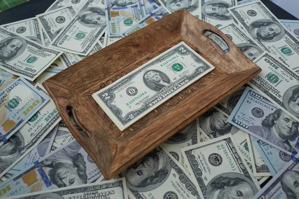 Money on a wooden tray — Stock Photo, Image