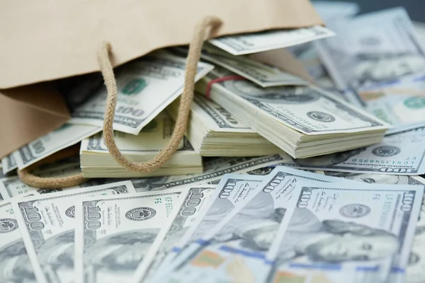 Dinheiro fora do saco de papel — Fotografia de Stock