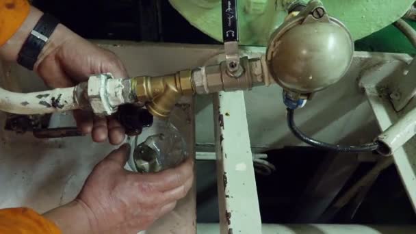 Man händer ta bort röret kork och dränera olja i plastflaska — Stockvideo